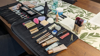Behind-the-scenes look at a meticulously organized makeup station with foundations, brushes, concealers, and skincare products laid out for a boudoir session at Icon Provocateur.