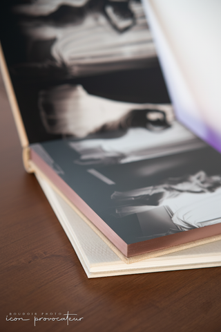 Close-up of an open boudoir album showcasing soft-touch pages and premium craftsmanship, part of the luxury product offerings at Icon Provocateur, Montreal’s inclusive boudoir studio.